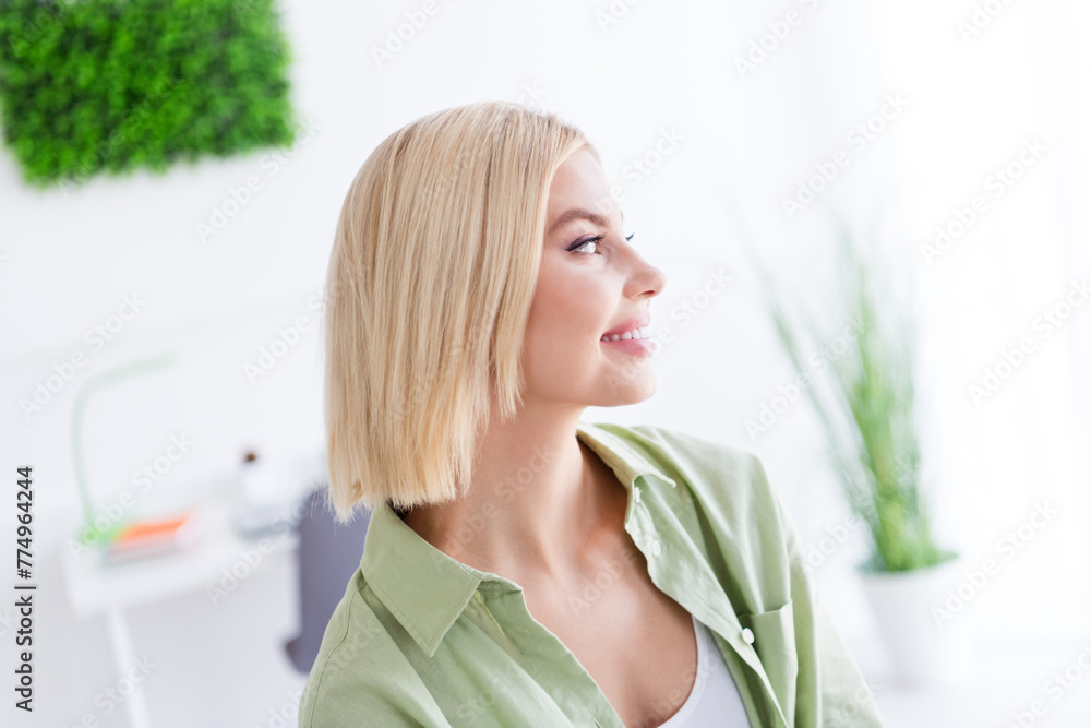 Side profile photo of cheerful blonde girlfriend smiling and looking curious at beautiful view daylight in window at home indoors Side profile photo of cheerful blonde girlfriend smiling and looking curious at beautiful view daylight in window at home indoors