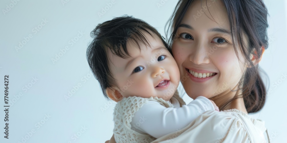portrait of young beauty Asian mother kissing her newborn baby boy's feet and having fun. portrait of young beauty Asian mother kissing her newborn baby boy's feet and having fun.