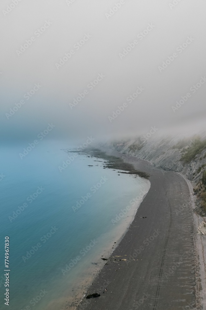 Vertical shot of sea water covering an empty sandy beach Vertical shot of sea water covering an empty sandy beach