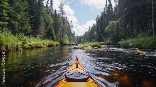 a man kayaking on a small narrow forest river surrounded by pine forest in summer