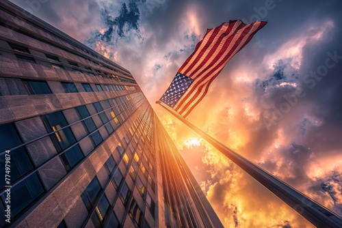 skyscrapper and american flag over sunset sky
