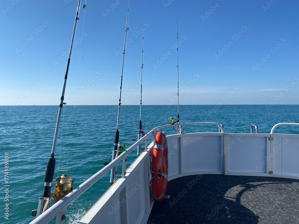 Fishing rods and the sea summer day boat photo 