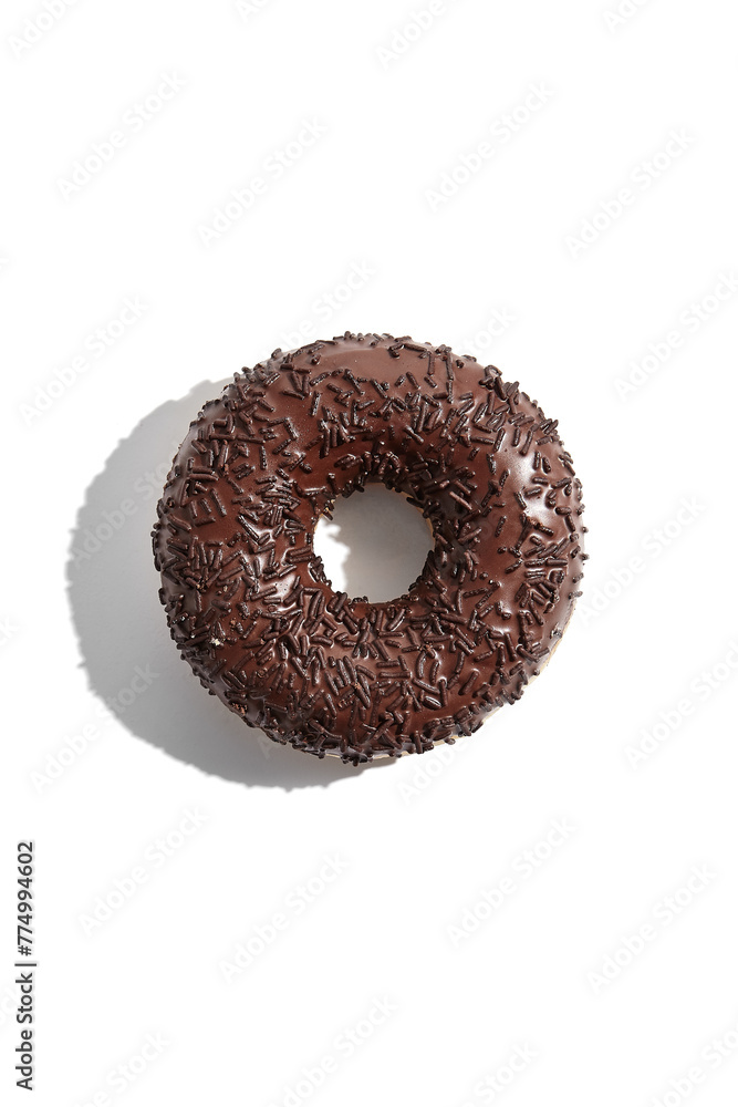 Chocolate glazed donut with chocolate sprinkles, top view isolated on a white background Chocolate glazed donut with chocolate sprinkles, top view isolated on a white background