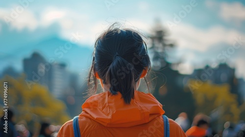Close-up of a person wearing an orange shirt on Orange Shirt Day, embodying the spirit of truth and reconciliation during their travels photo