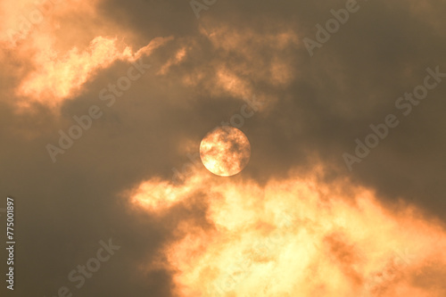 Sun through the clouds. Burning fire in the sky