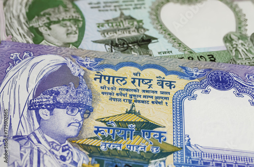Closeup of Nepal 1 and 2 rupees banknotes currency 1995 - 2000 series with King Birendra (focus on center)