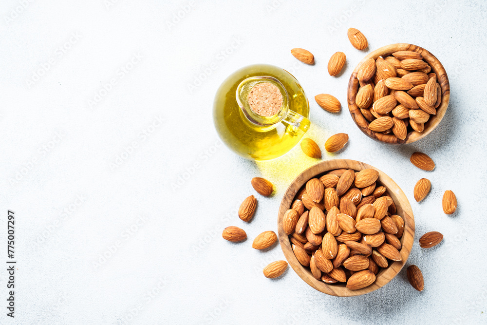 Almond nuts in wooden bowl at white background. Almond nuts in wooden bowl at white background.