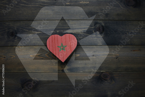 wooden heart with national flag of morocco near reduce, reuse and recycle sing on the wooden background. concept