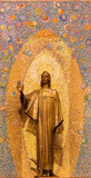 MILAN, ITALY - MARCH 8, 2024: The bronze statue of St. John the Evangelist in the church Chiesa di Santi Quattro Evangelisti by Mario Zappettini from 20. cent.