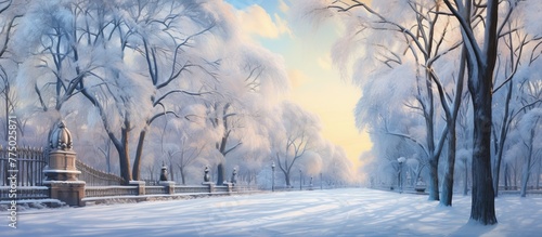 A tranquil winter landscape depicting a park covered in snow, featuring a wooden fence and various trees creating a peaceful atmosphere photo