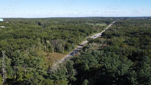 Aerial view of a road through a dense forest in Smithfield, Rhode Island photo