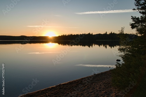 Beautiful bright sunrise over the lake shore