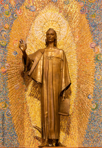 MILAN, ITALY - MARCH 8, 2024: The bronze statue of St. John the Evangelist in the church Chiesa di Santi Quattro Evangelisti by Mario Zappettini from 20. cent.