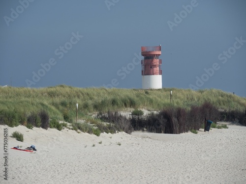 Scenic view of a lighthouse located on the shore of a beach photo