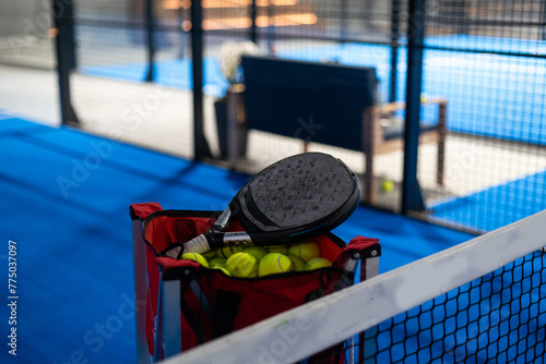 Paddle tennis rackets, balls and basket in court still life © Angelov