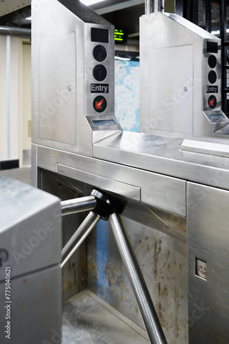 Turnstile barrier entry to public mass transit commuter subway train in New York City photo