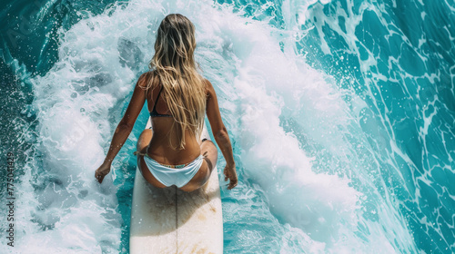 Surfing woman on a surfboard photo