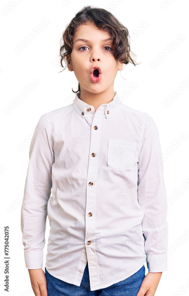 Cute hispanic child wearing casual clothes scared and amazed with open mouth for surprise, disbelief face Cute hispanic child wearing casual clothes scared and amazed with open mouth for surprise, disbelief face