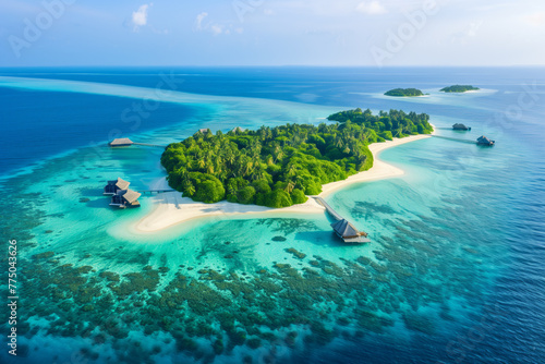 Aerial view of a vibrant turquoise atoll with lush green islands scattered throughout, surrounded by the vast Indian Ocean