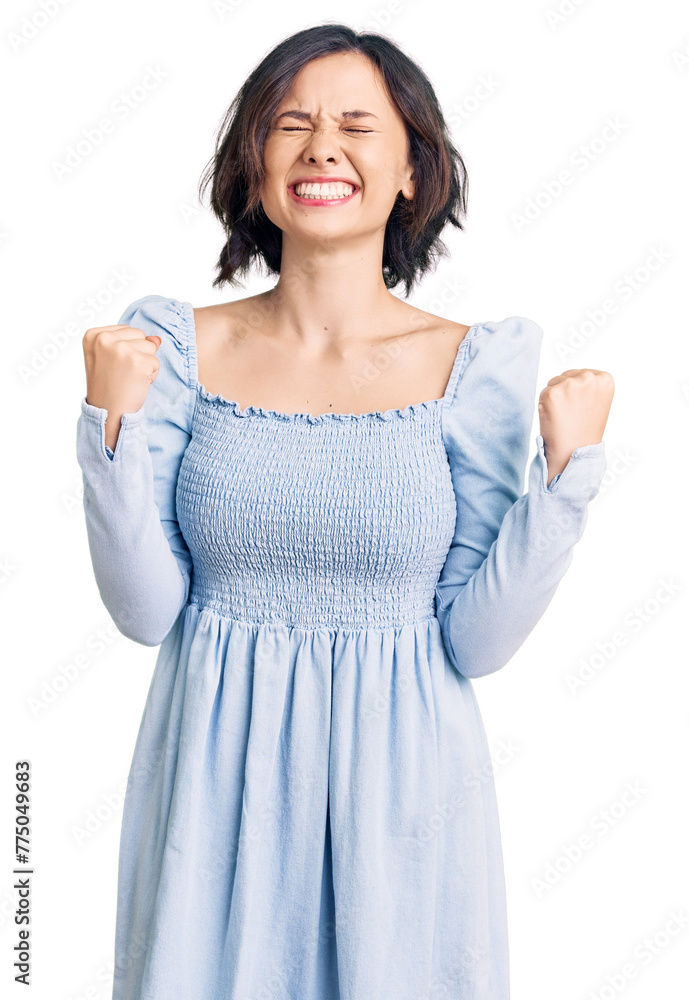 Young beautiful girl wearing casual clothes very happy and excited doing winner gesture with arms raised, smiling and screaming for success. celebration concept. Young beautiful girl wearing casual clothes very happy and excited doing winner gesture with arms raised, smiling and screaming for success. celebration concept.
