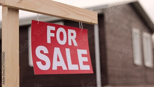 Home For Sale Signboard in Front of New House in Slow Motion. Close up.