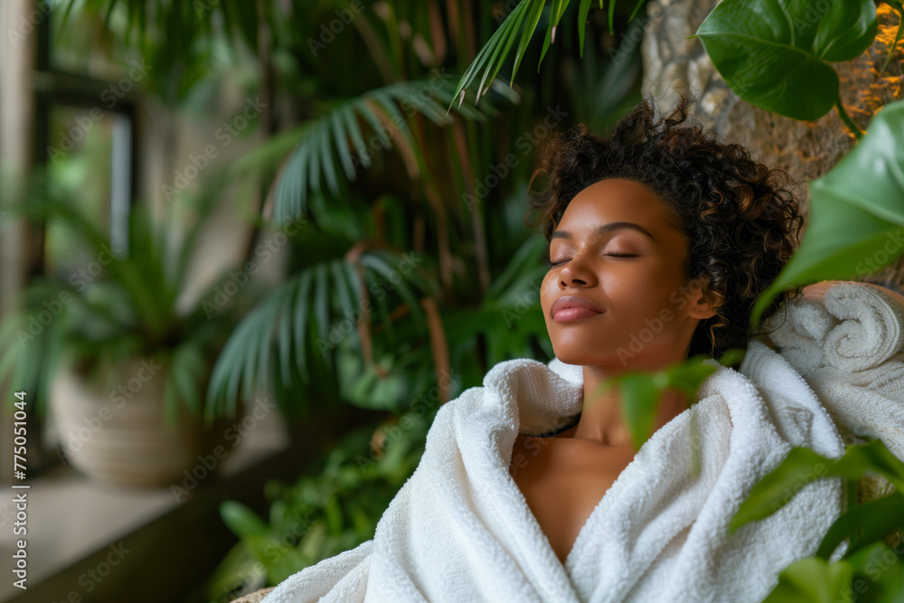 Tranquil African American woman relaxing in a spa setting with lush greenery.