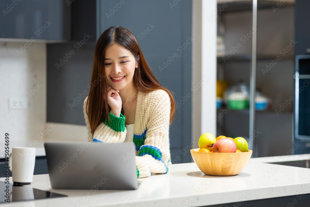 Happy woman relaxing at home - young Asian woman Relaxed working with computer at home. remote working from home office during quarantine Happy woman relaxing at home - young Asian woman Relaxed working with computer at home. remote working from home office during quarantine