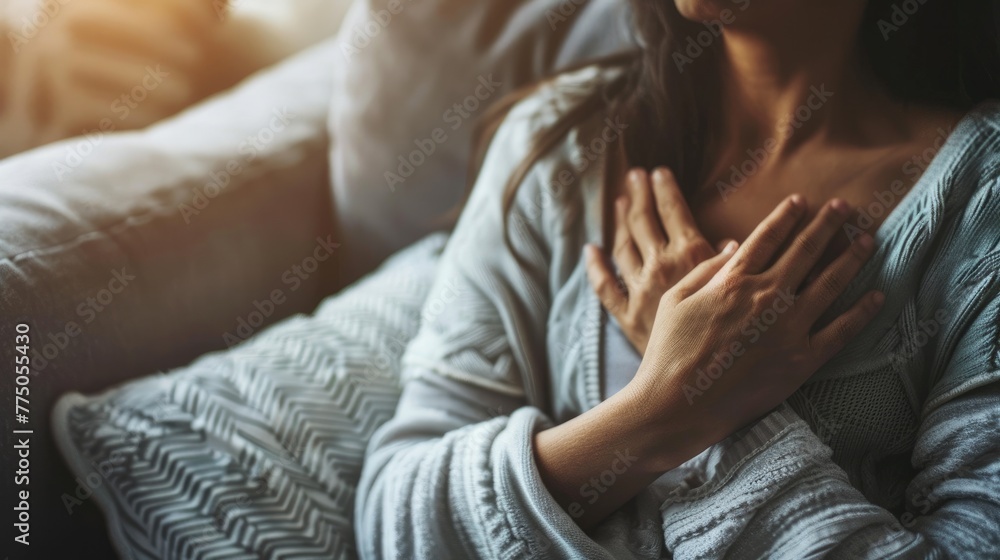 Sick Woman is clutching her chest on couch, acute pain possible heart attack. Sick Woman is clutching her chest on couch, acute pain possible heart attack.
