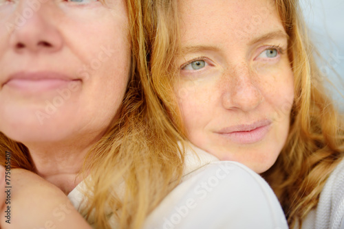 Cute woman tenderly hugs her mature mother on Mother's Day