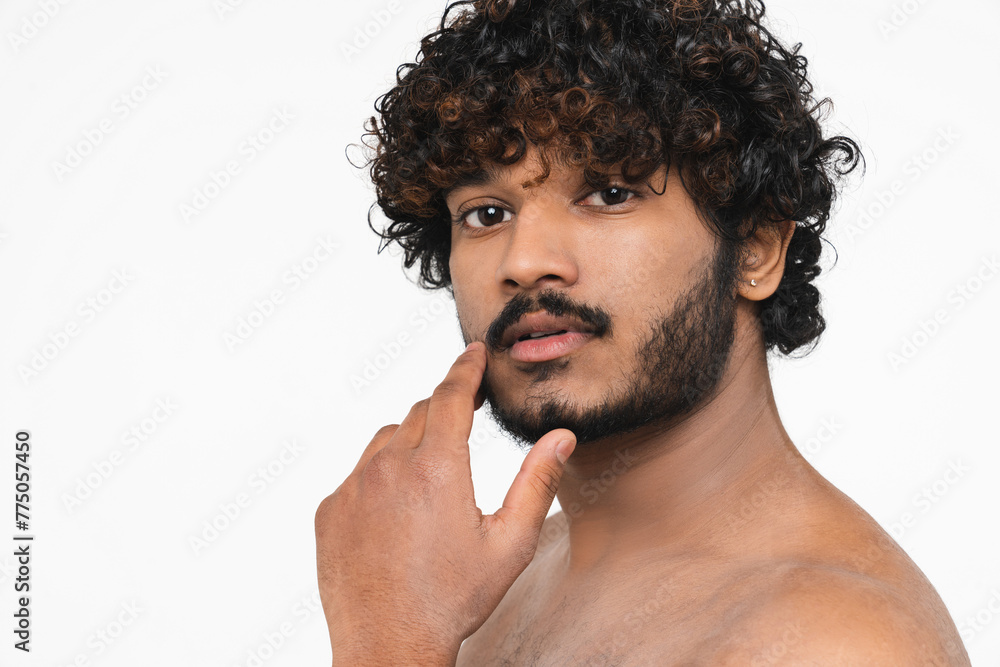 Young Hindu man no shirt touching his beard looking at camera isolated over white background. Handsome Indian boy preparing for shaving his facial hair. Beauty concept Young Hindu man no shirt touching his beard looking at camera isolated over white background. Handsome Indian boy preparing for shaving his facial hair. Beauty concept