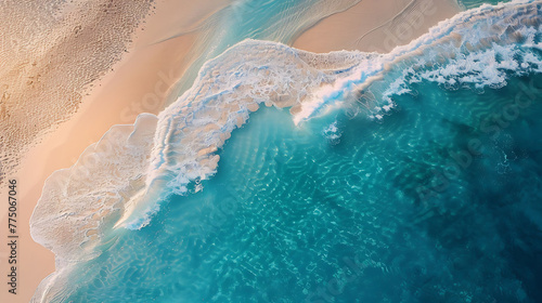 An aerial view of a pristine beach with turquoise waters lapping at the shore