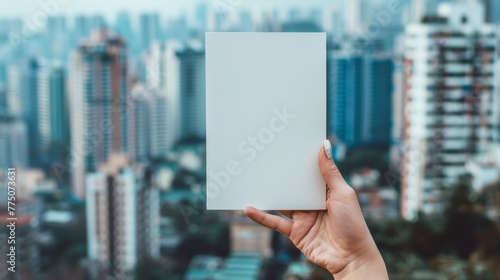 A person holding up a blank white card in front of cityscape, AI