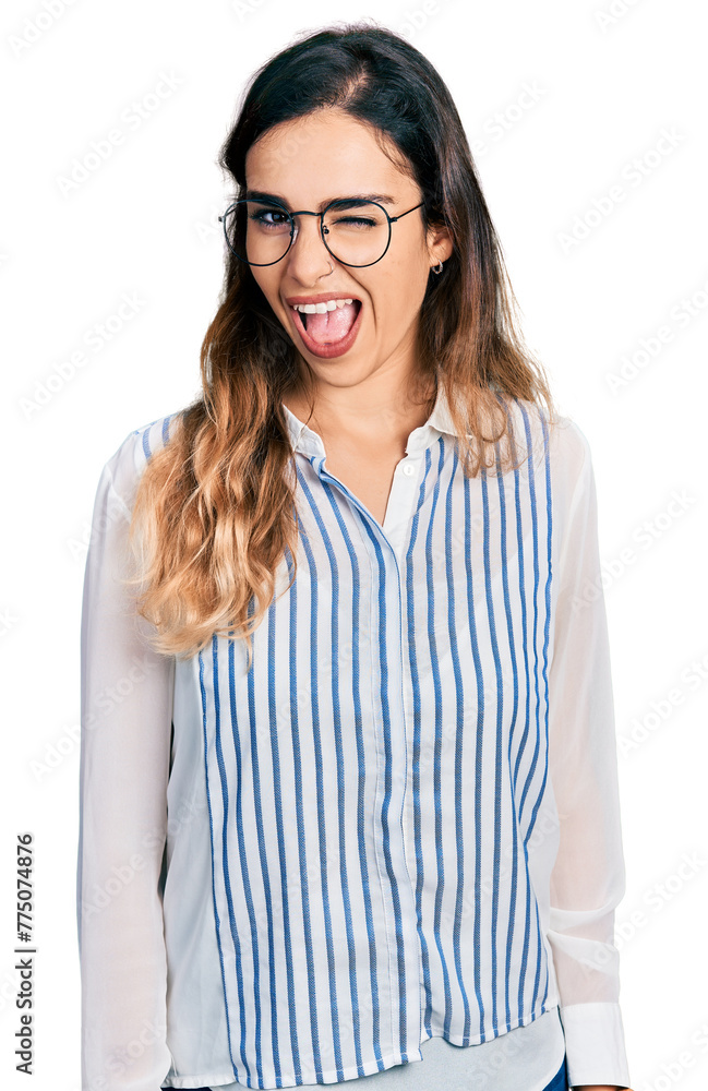 Beautiful hispanic woman wearing casual striped shirt winking looking at the camera with sexy expression, cheerful and happy face. Beautiful hispanic woman wearing casual striped shirt winking looking at the camera with sexy expression, cheerful and happy face.