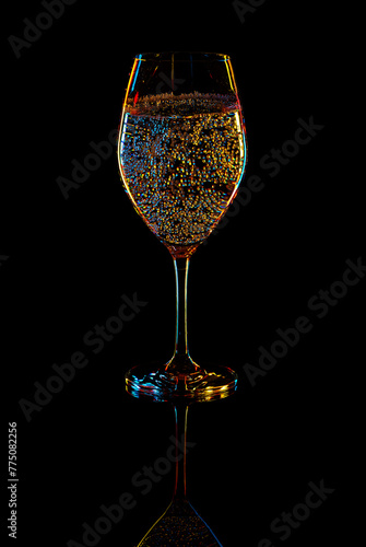 White Wine Glasse with sparkling water over Black Background.