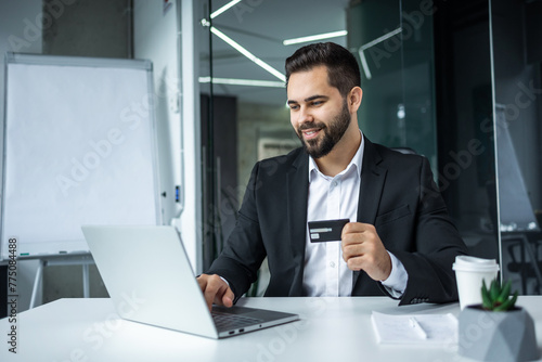 Happy man, business credit card and laptop for ecommerce, finance and accounting in office. Manager, computer and financial payment of budget