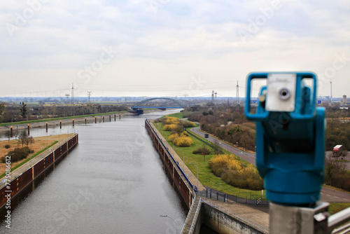 View over canals near Magdeburg with coin-operated binoculars in blurred foreground