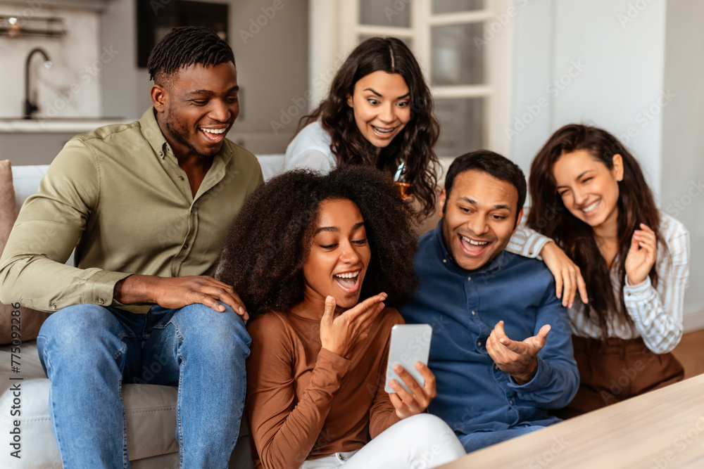 Group of friends laughing with smartphone at home Group of friends laughing with smartphone at home