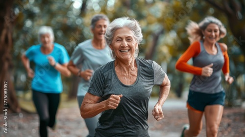 The main focus is on the face of a mature woman in the center of the frame. Fit older people running in a city park - Group of older friends working out together outdoors