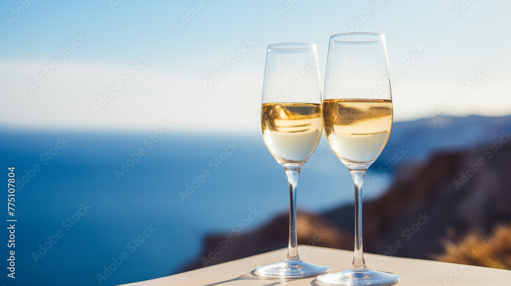 Glasses with sparkling wine on the seascape background