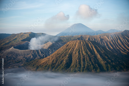 Mount Bromo with smoke, Mount Batok at front, and Mt Gunung Semeru at back, volcano, eruption, Bromo Tengger Semeru Indonesia photo