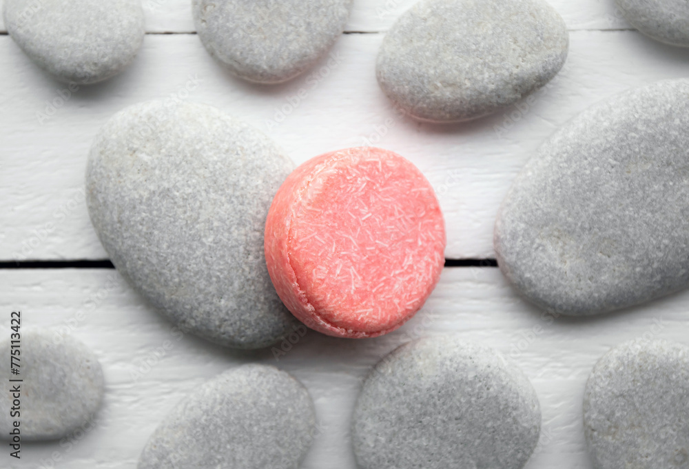 Flat lay view of pink color solid shampoo bar, conditioner bar on flat sea stones. Minimalist beauty set indoors. Shallow depth of field.
 - obrazy, fototapety, plakaty 