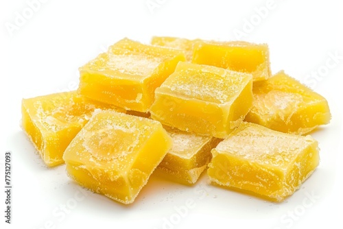 Yellow, cubed lemon jelly candies on a white background, perfect for sweet shops, confectionery marketing, and recipe websites.