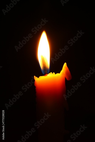 Candle light on dark background photo vertical