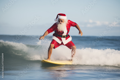 Santa Claus surfing a wave in the ocean in his full Christmas regalia; X-Mas in July background image