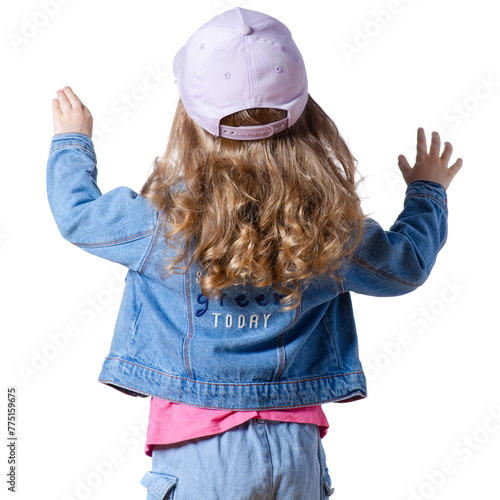Portrait of a beautiful kid girl in cap and jeans jacket happiness, hands raised up on white background isolation. back rear view