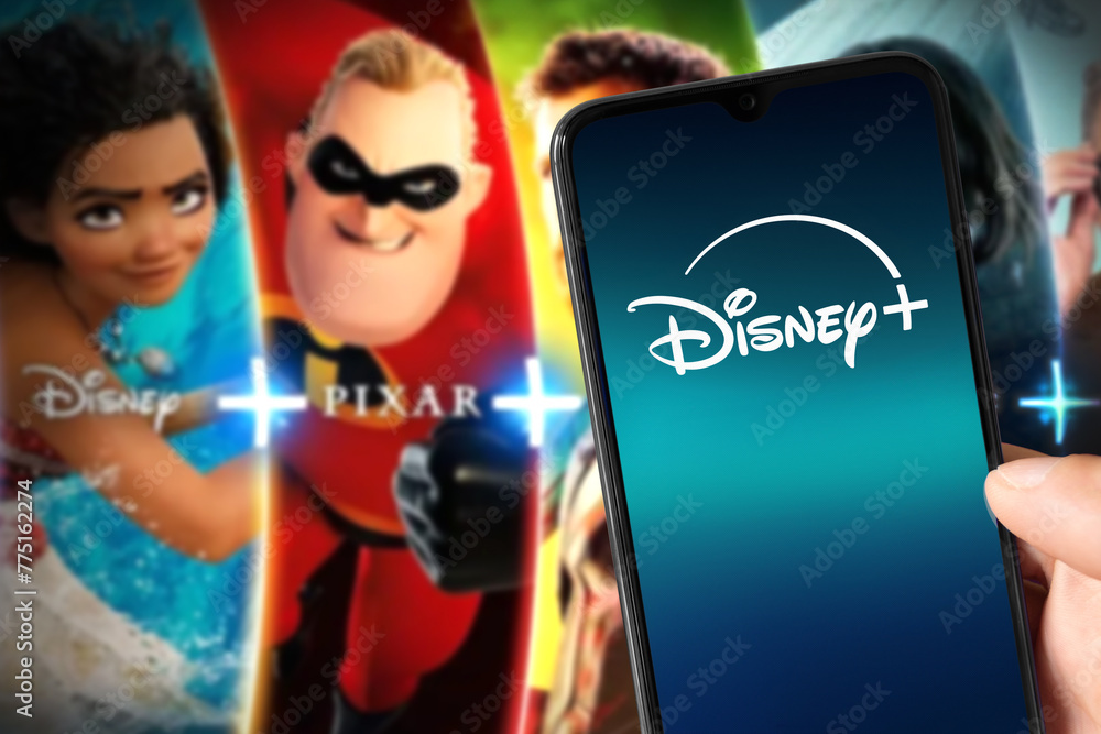 Obraz premium Smartphone with new Disney Plus logo with Disney Plus content on background, 3 Mar, 2024, Sao Paulo, Brazil.
