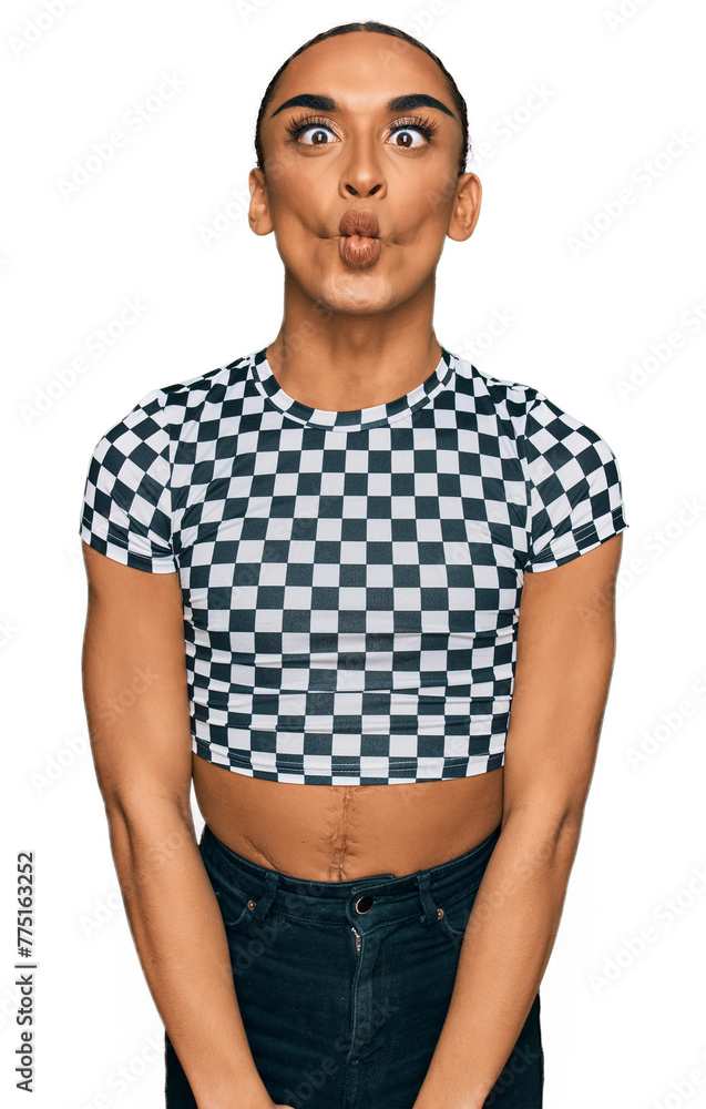 Hispanic transgender man wearing make up and long hair wearing modern clothes making fish face with lips, crazy and comical gesture. funny expression. Hispanic transgender man wearing make up and long hair wearing modern clothes making fish face with lips, crazy and comical gesture. funny expression.