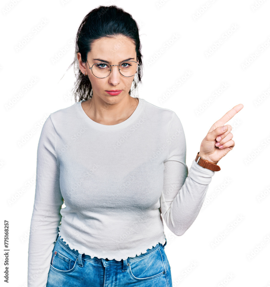 Young hispanic woman pointing with fingers to the side skeptic and nervous, frowning upset because of problem. negative person. Young hispanic woman pointing with fingers to the side skeptic and nervous, frowning upset because of problem. negative person.
