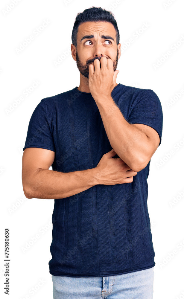 Young hispanic man wearing casual clothes looking stressed and nervous with hands on mouth biting nails. anxiety problem. Young hispanic man wearing casual clothes looking stressed and nervous with hands on mouth biting nails. anxiety problem.