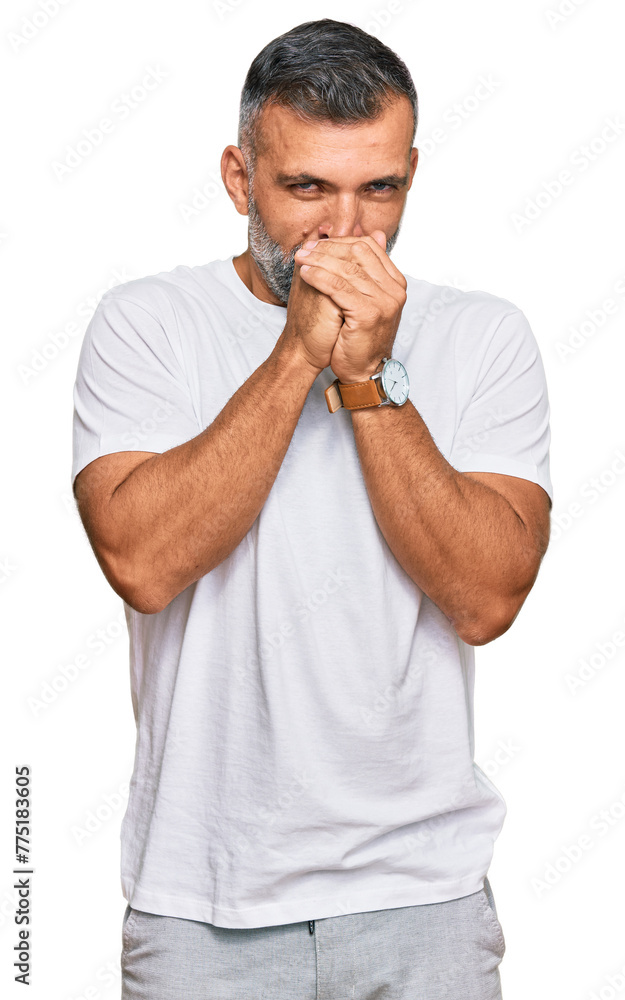 Middle age handsome man wearing casual white tshirt laughing nervous and excited with hands on chin looking to the side Middle age handsome man wearing casual white tshirt laughing nervous and excited with hands on chin looking to the side